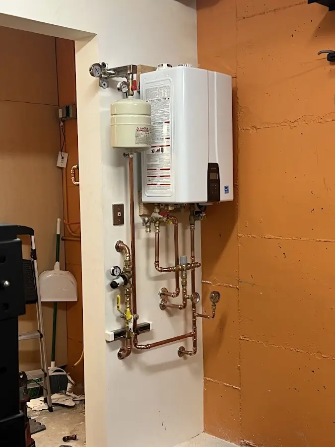 Plumbing technician inspecting water heater connections in Nocatee
